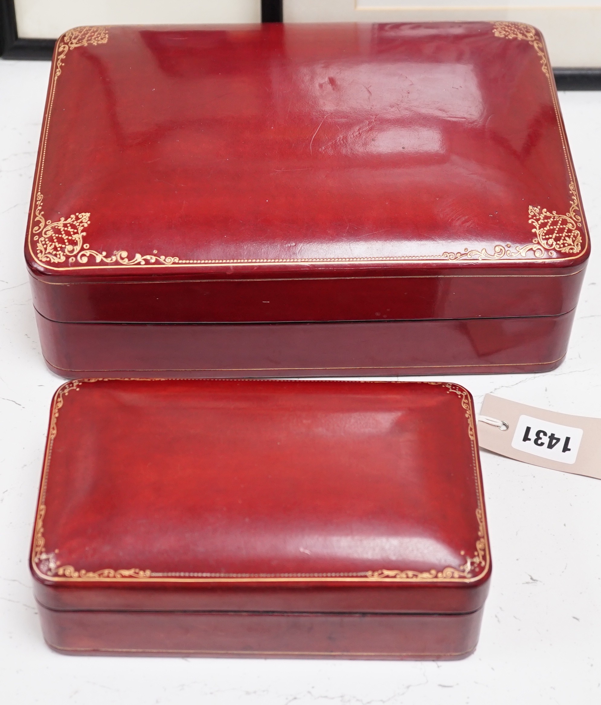 Two red leather boxes, Largest 26.5 cm wide